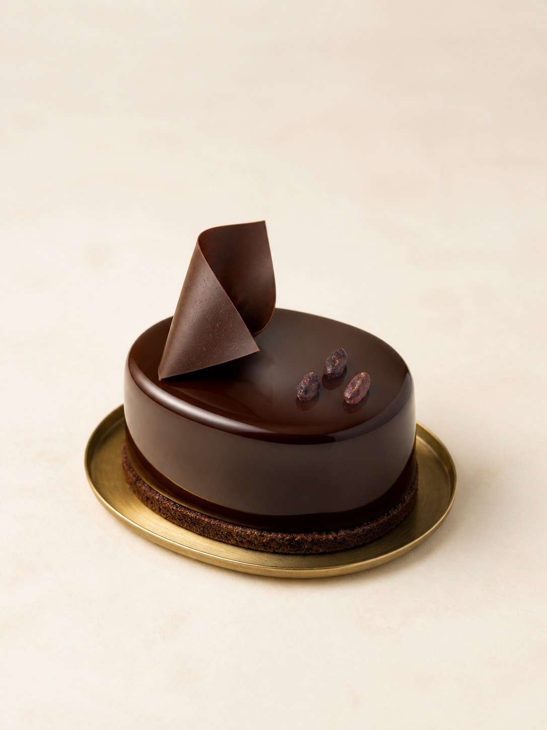 Oval chocolate cake on a golden plate
